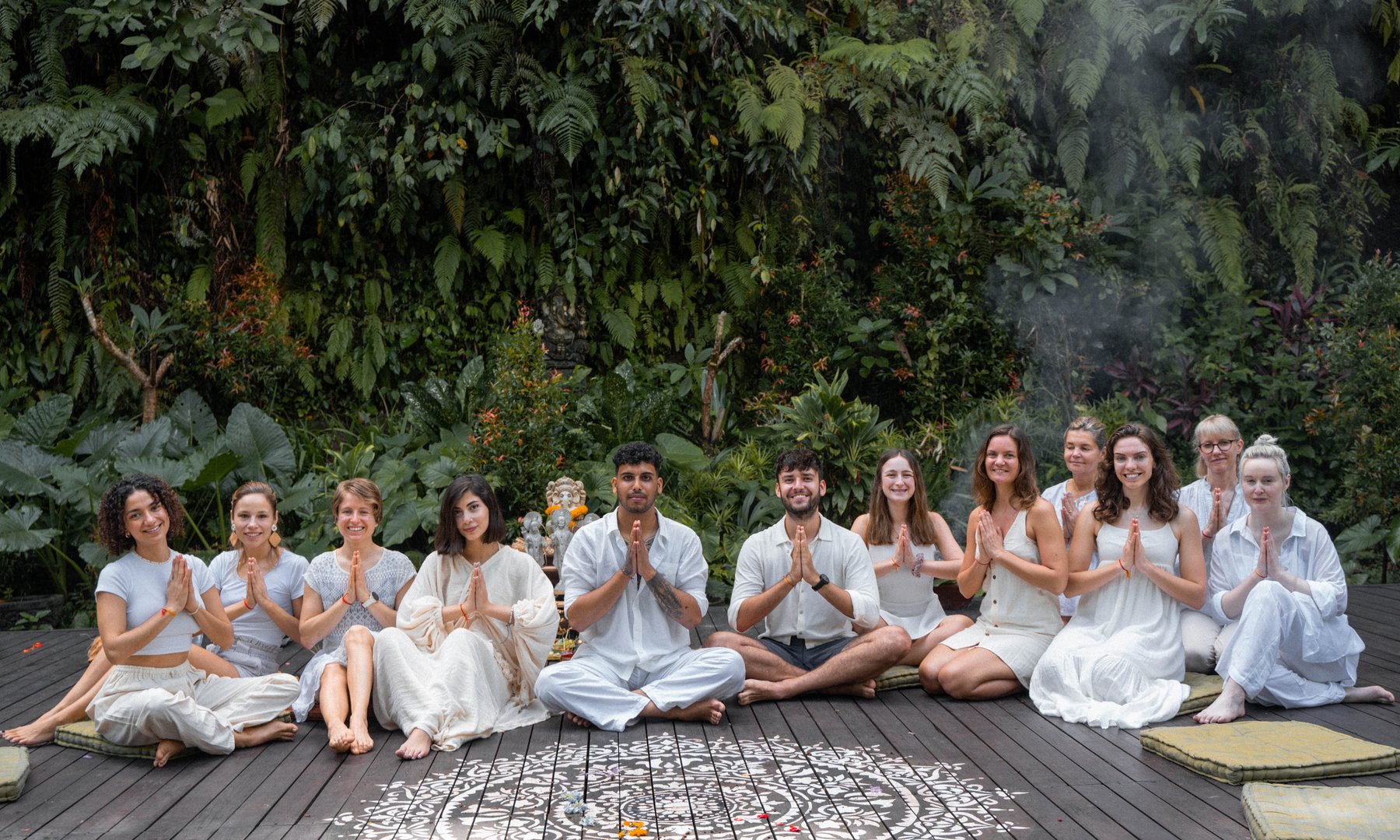 Yoga teacher training cohort during prayer ceremony in Kerala shala